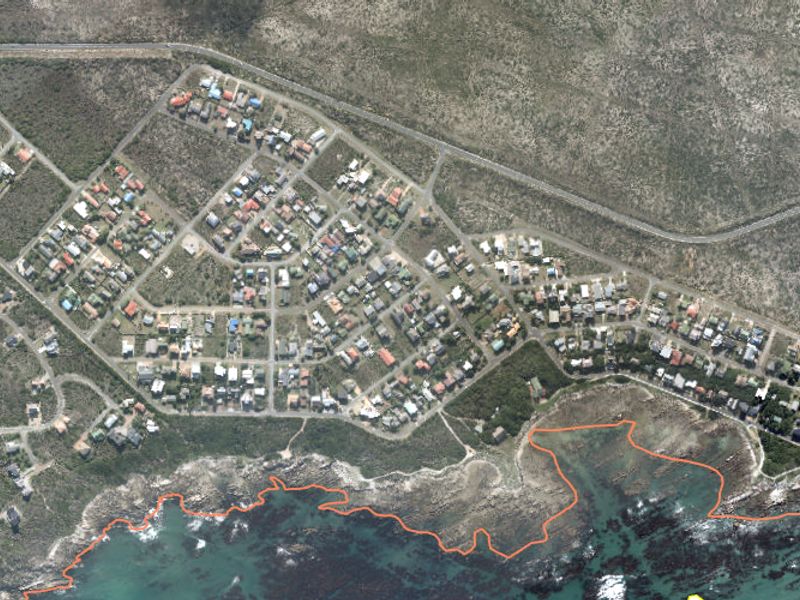 An aerial view of a coastal residential neighborhood showing the layout of properties in relation to the shoreline.