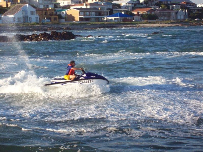 A view of the coastal landscape and residential properties from the water.