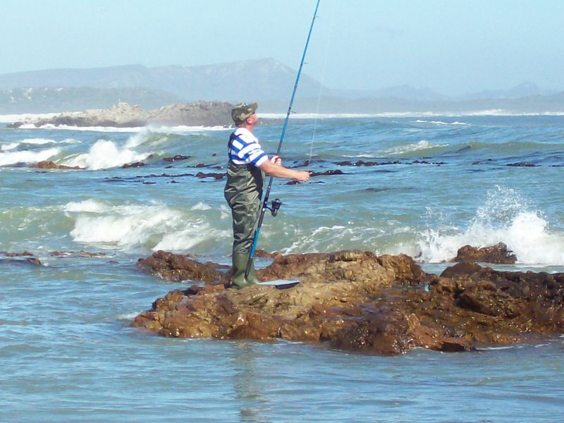 A scenic coastal view featuring rocky shoreline and ocean waves, highlighting the natural landscape and recreational potential of the area.