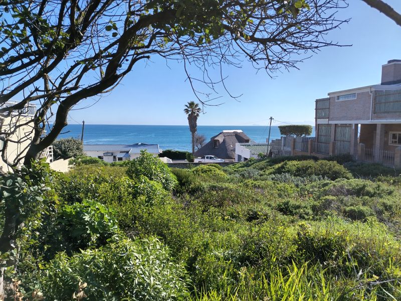 A scenic view overlooking the coastal landscape and ocean, showcasing the natural beauty and surroundings of the residential land.