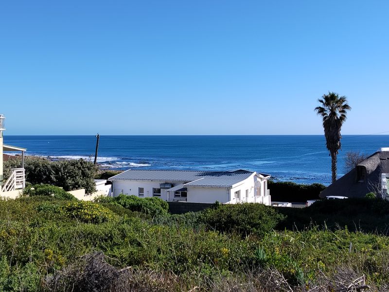 A scenic elevated view overlooking the coastline and ocean, showcasing the property's prime location and natural surroundings.