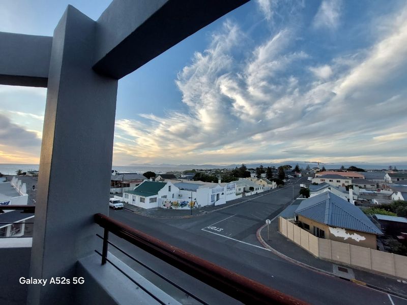 Elevated coastal view overlooking the surrounding neighborhood and streetscape from a private balcony.