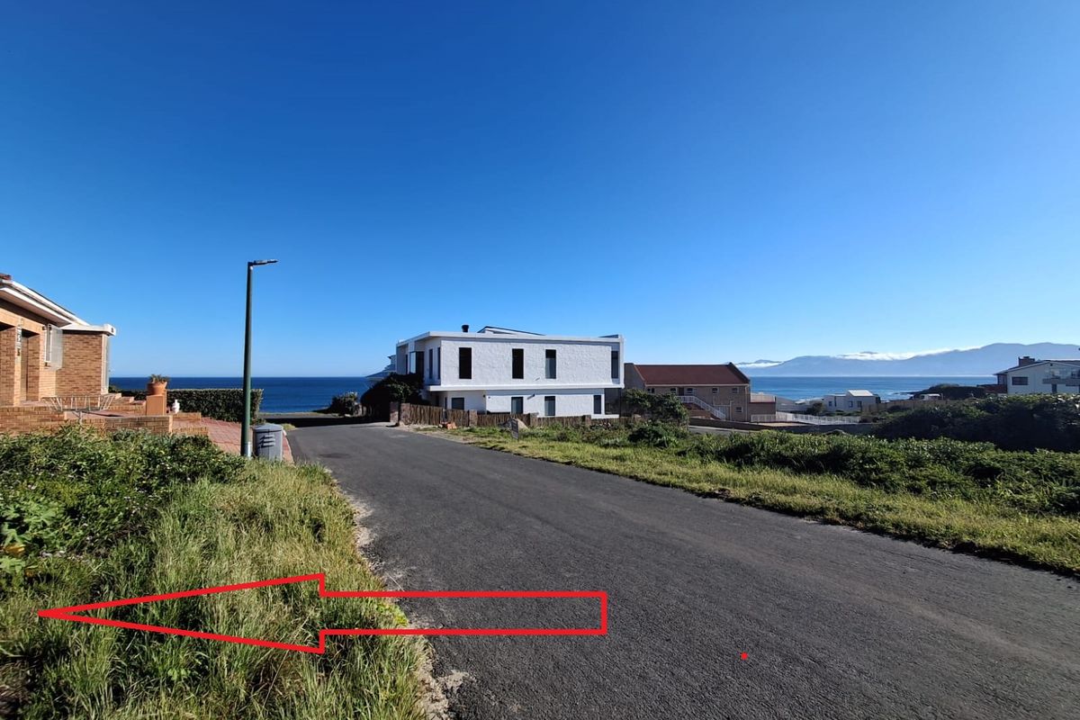 A street view showing the paved road access and surrounding coastal residential neighborhood setting.