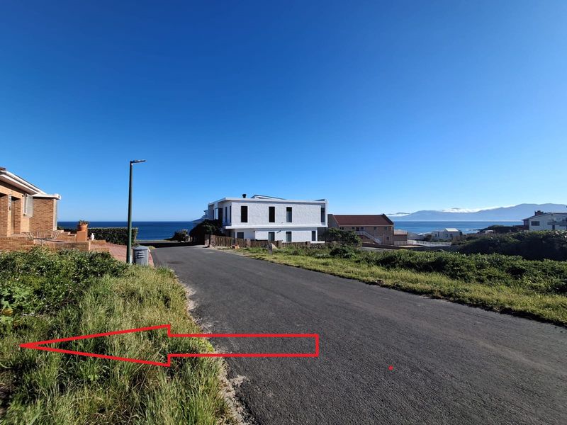 A street view showing the paved road access and surrounding coastal residential neighborhood setting.