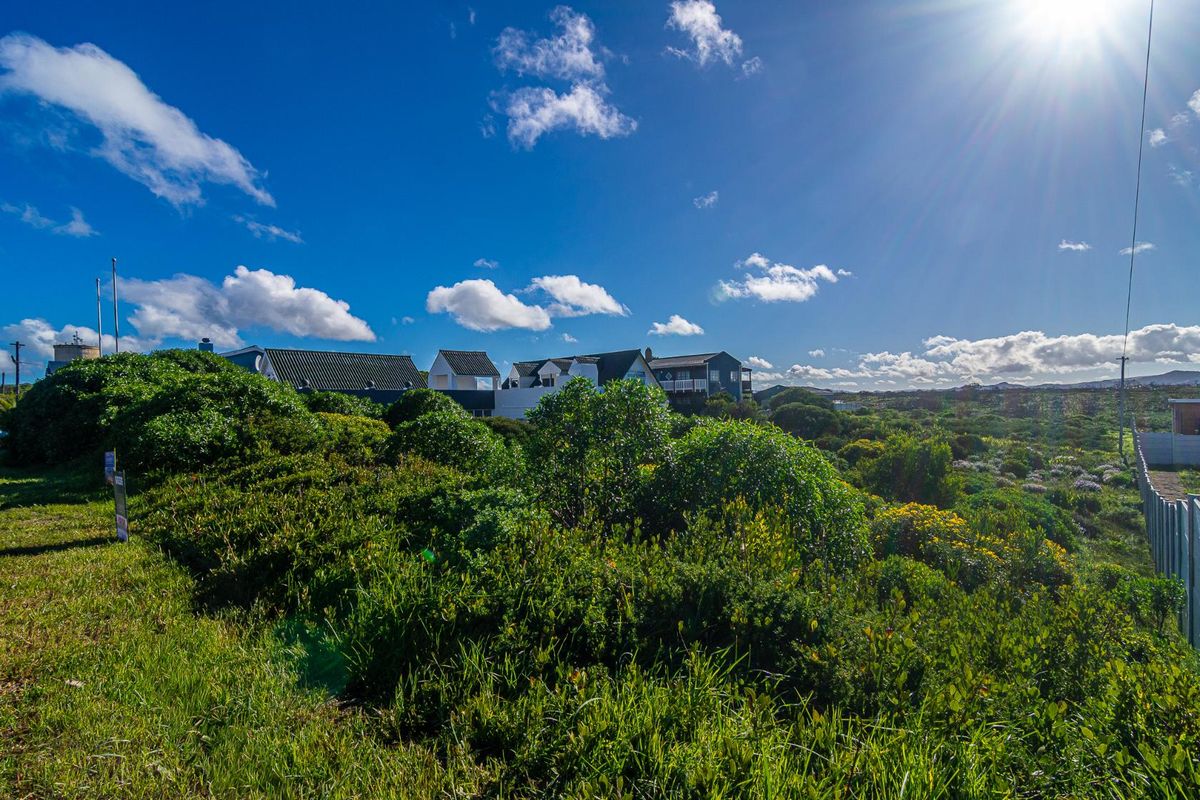 A scenic view of the surrounding coastal landscape and natural vegetation, showcasing the open environment of the residential land.