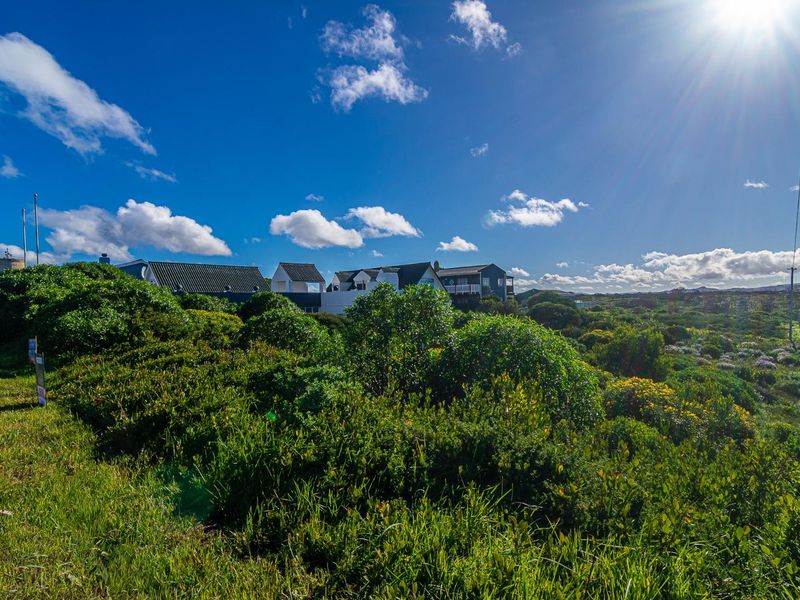 A scenic view of the surrounding coastal landscape and natural vegetation, showcasing the open environment of the residential land.