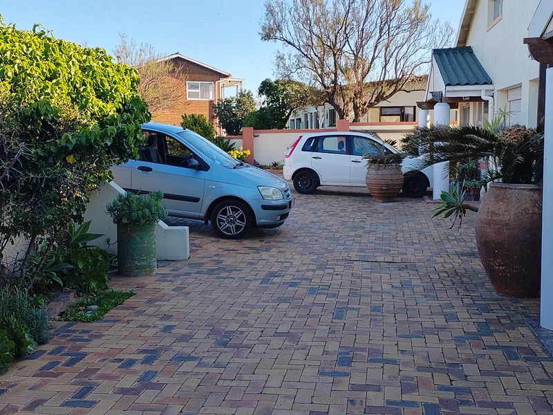 A paved front driveway providing off-street parking, leading to the main entrance of the house.