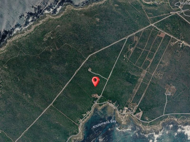 An aerial view showing the location of the vacant residential land parcel situated near the coastline.