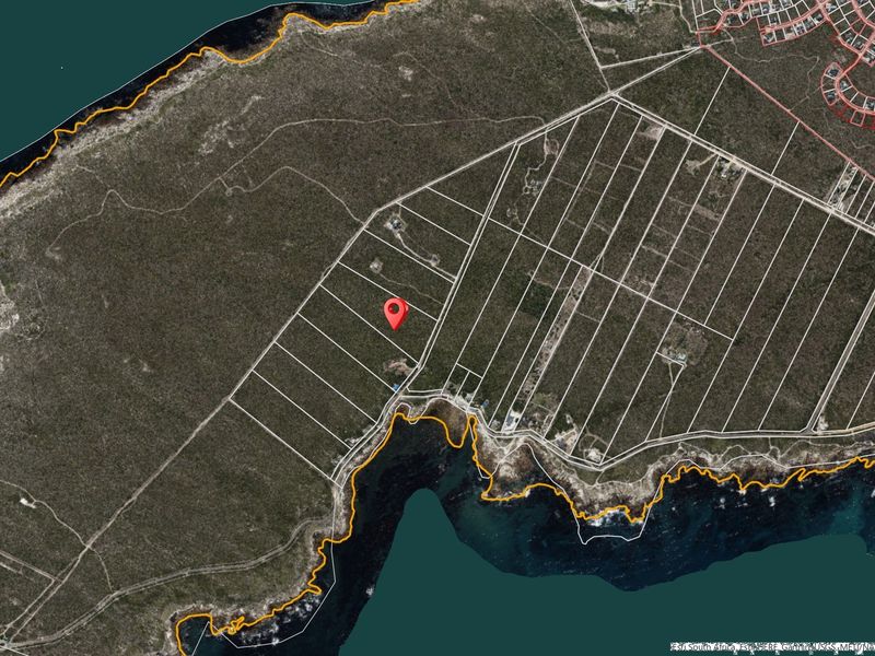 An aerial satellite view showing the layout of coastal residential land parcels and their proximity to the shoreline.