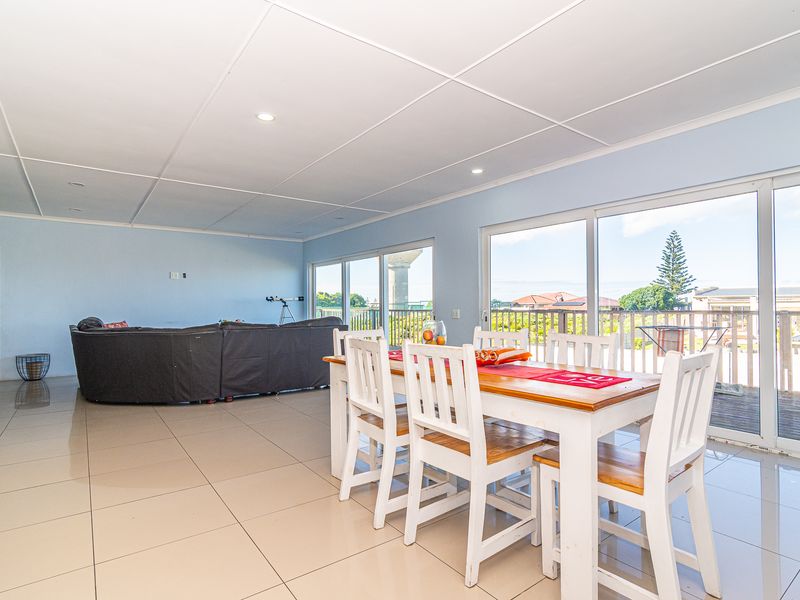 Spacious open-plan living and dining area featuring large sliding glass doors that provide natural light and direct access to the balcony.