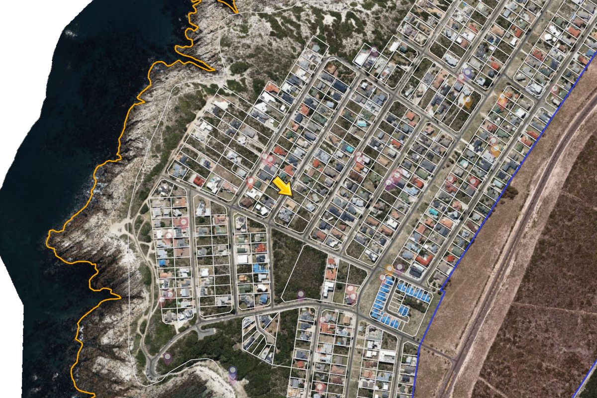 An aerial satellite view of a residential coastal neighborhood showing the property location and surrounding street layout.