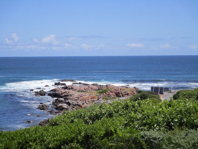 A scenic view of the rocky coastline and ocean, showcasing the natural beauty of the property's surroundings.