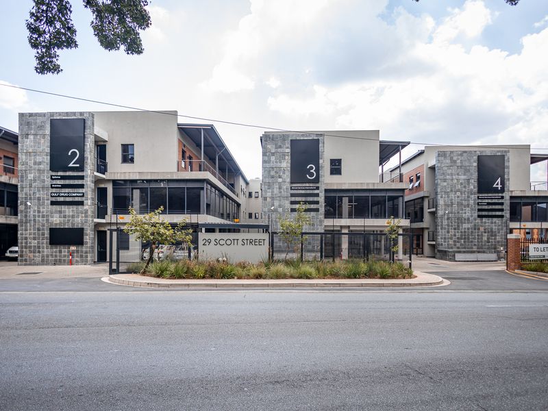 Modern multi-unit office complex at 29 Scott Street featuring stone facade accents, large glass windows, and secure gated access.
