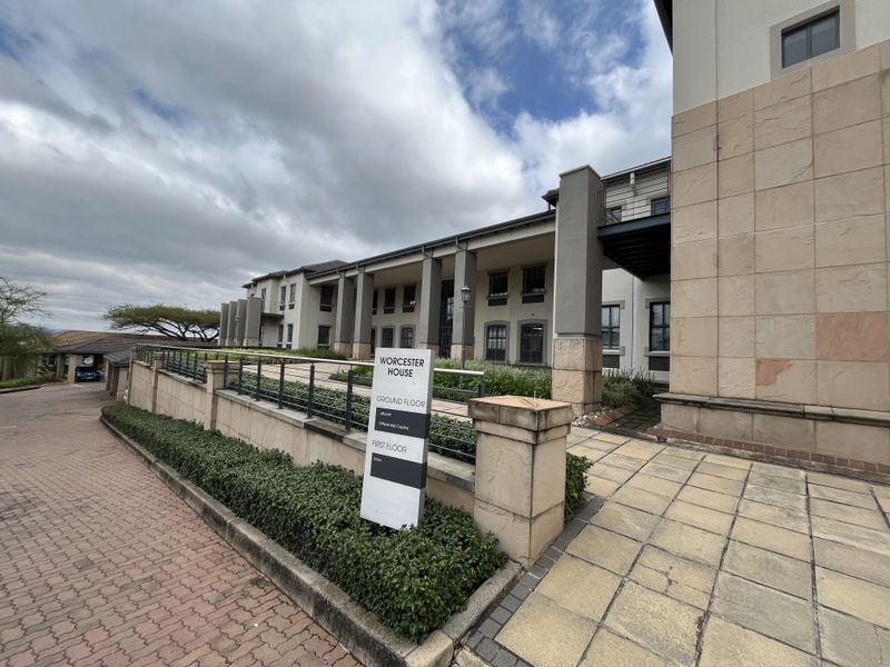 Exterior view of Worcester House office building featuring stone facade, paved walkways, and professional signage in a well-maintained landscaped setting.