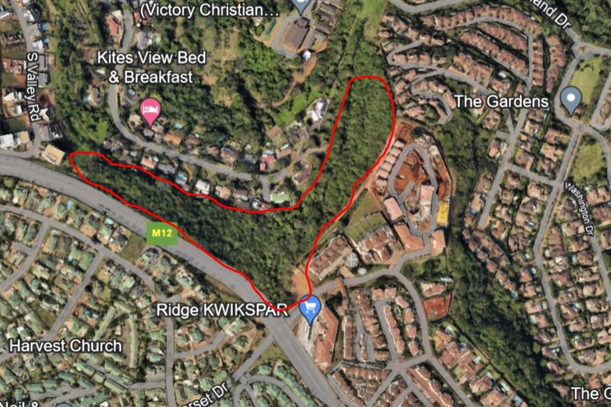 An aerial view showing the location and boundaries of the vacant residential land plot within the established neighborhood.