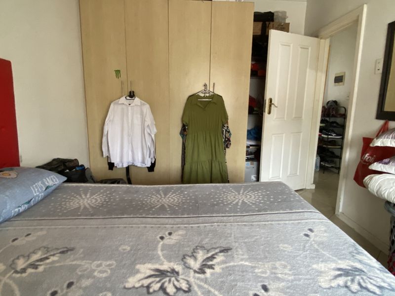 A bedroom featuring a built-in wardrobe and access to an adjacent hallway.