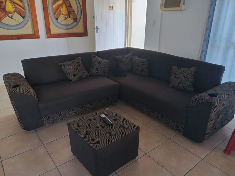 A living room area featuring ceramic floor tiles and a wall-mounted air conditioning unit.