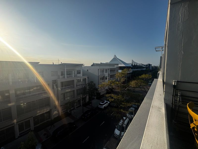 An elevated view overlooking the surrounding apartment complex and street from a private balcony.