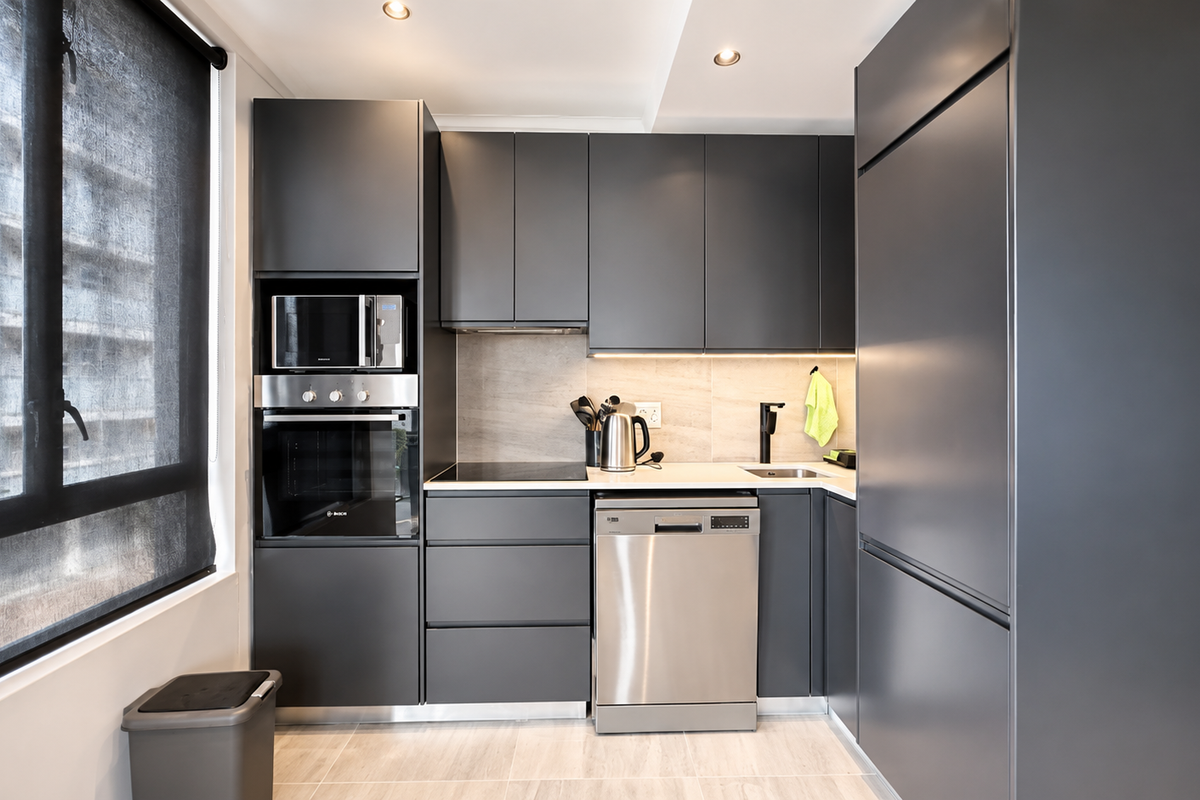 Modern kitchen featuring matte grey cabinetry, integrated appliances, stone countertops, and recessed lighting, offering a sleek and functional culinary space.