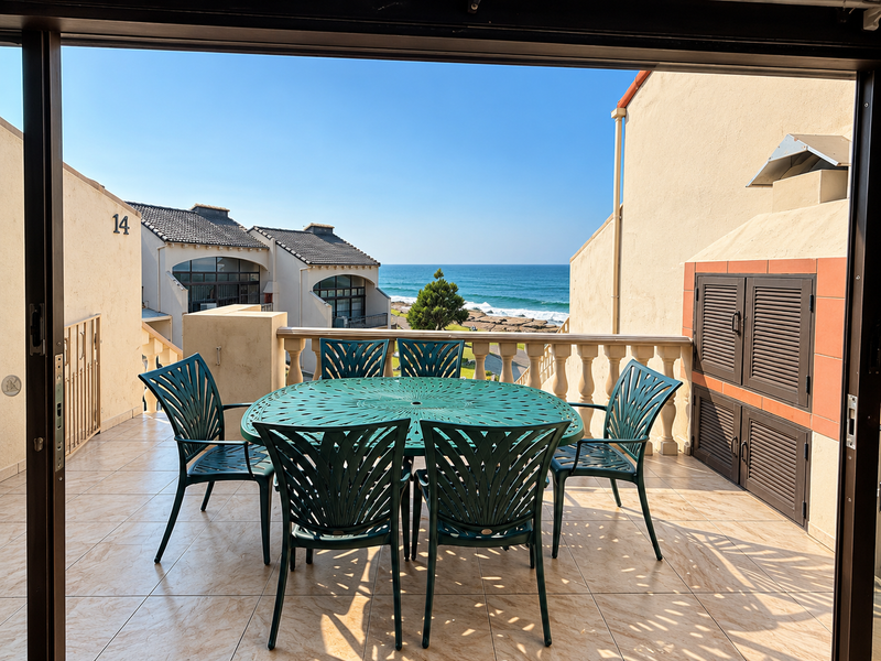 Spacious balcony featuring a built-in braai, tiled flooring, and a balustrade, offering stunning ocean views.