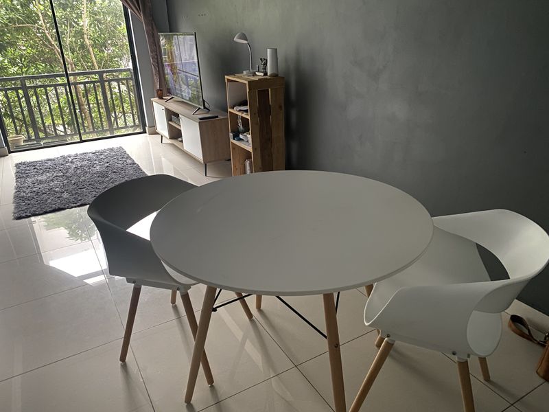 Open plan living and dining area featuring tiled flooring and a sliding glass door leading to a balcony with greenery views.