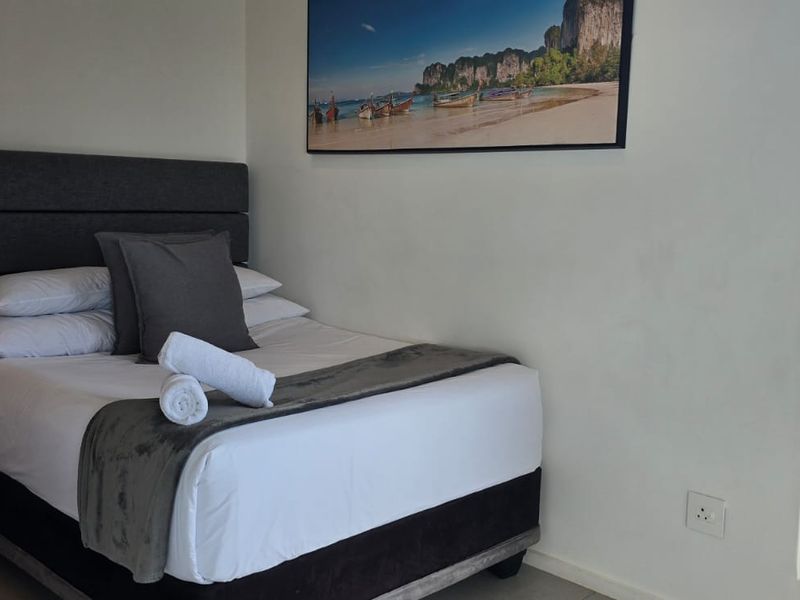 A modern bedroom featuring a sliding glass door that provides natural light and access to an outdoor area.