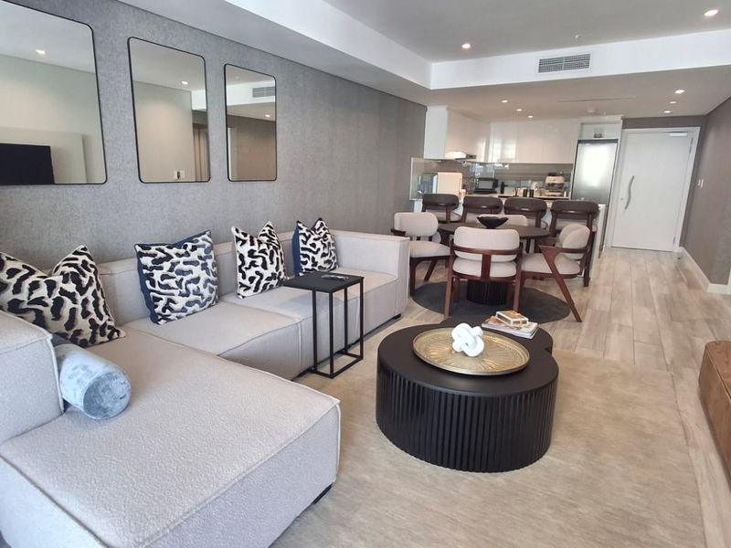 Modern open-plan living and dining area featuring contemporary finishes, recessed lighting, ducted air conditioning, and a sleek, well-appointed kitchen.