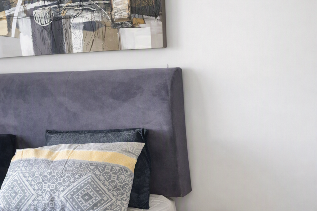 A well-maintained bedroom featuring neutral wall finishes and tiled flooring.