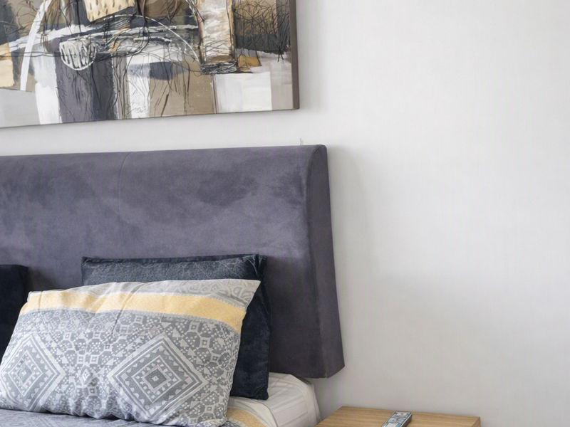 A well-maintained bedroom featuring neutral wall finishes and tiled flooring.