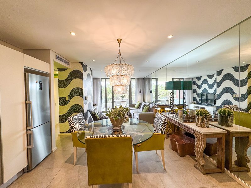 Spacious open-plan living and dining area featuring tiled floors, a large mirrored wall, recessed lighting, and integrated air conditioning.