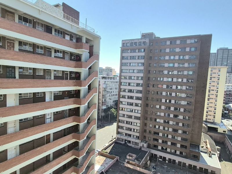 An elevated urban view overlooking surrounding high-rise apartment buildings and city street infrastructure.
