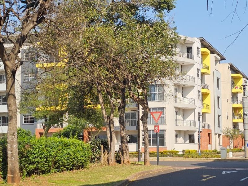 A view of the apartment complex facade featuring multi-story residential units with balconies and modern architectural finishes.