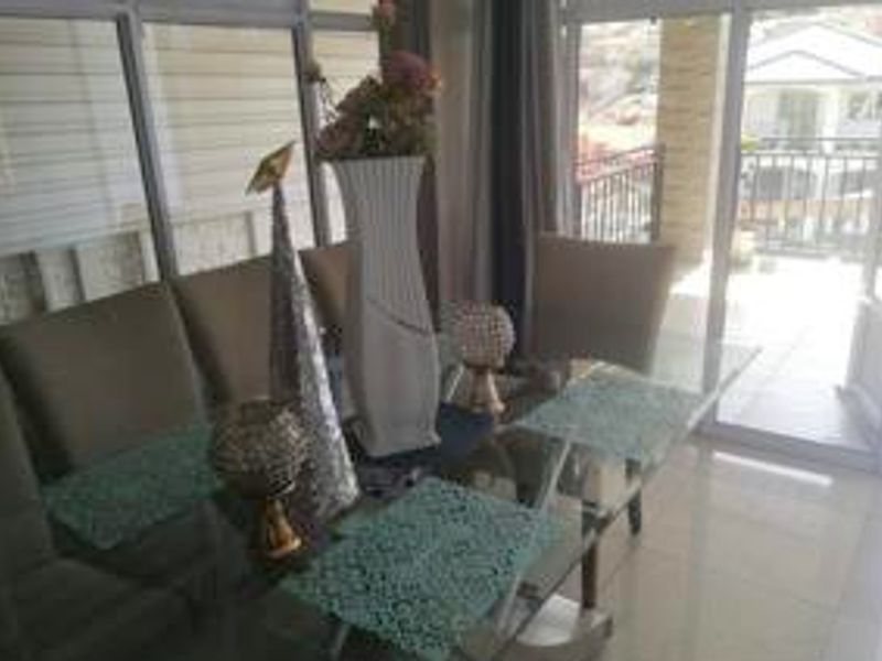 A dining area featuring tiled flooring and large sliding glass doors that provide natural light and access to the outdoor space.