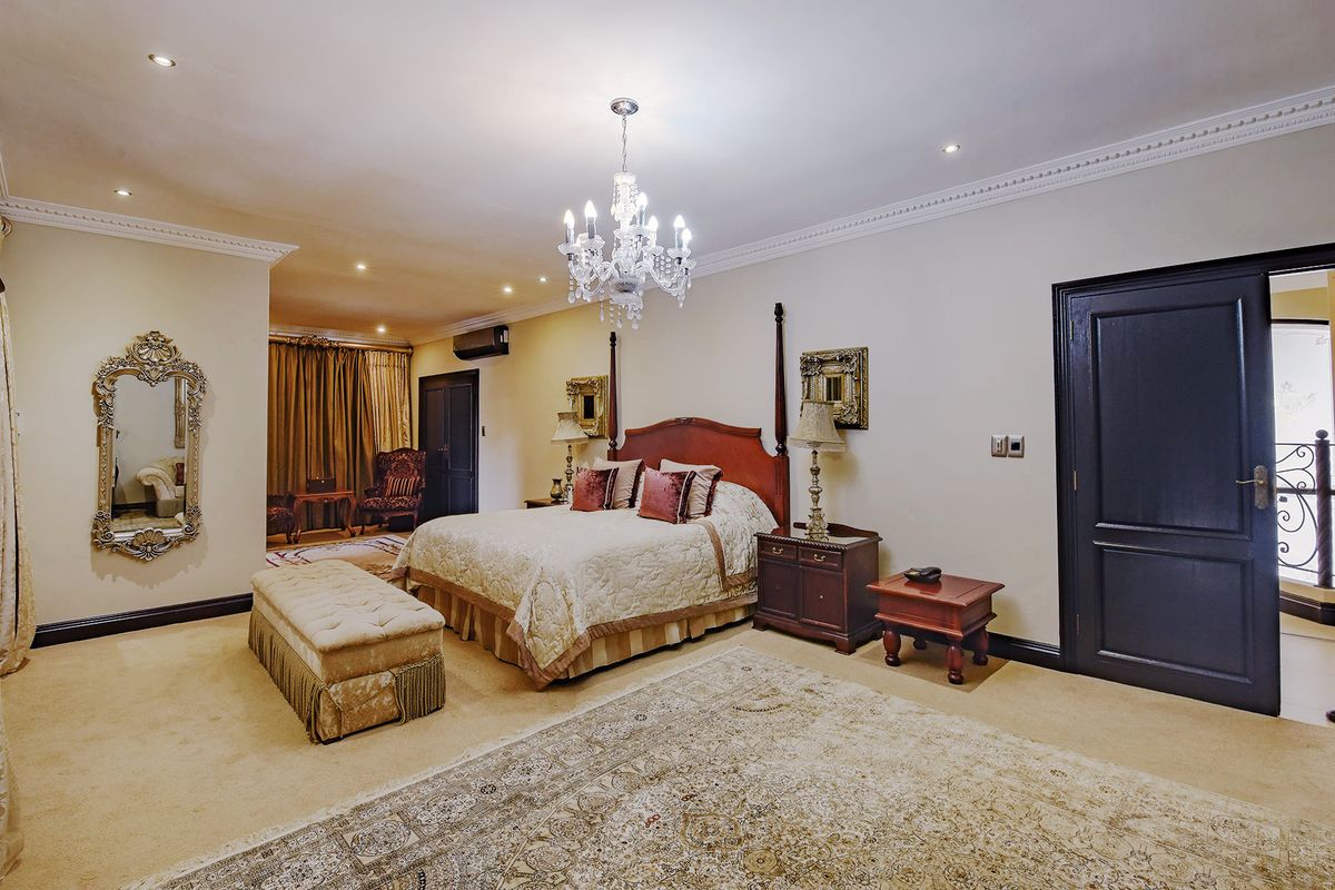 Spacious primary bedroom featuring crown molding, recessed lighting, and an integrated air conditioning unit, offering a comfortable and well-maintained living space.