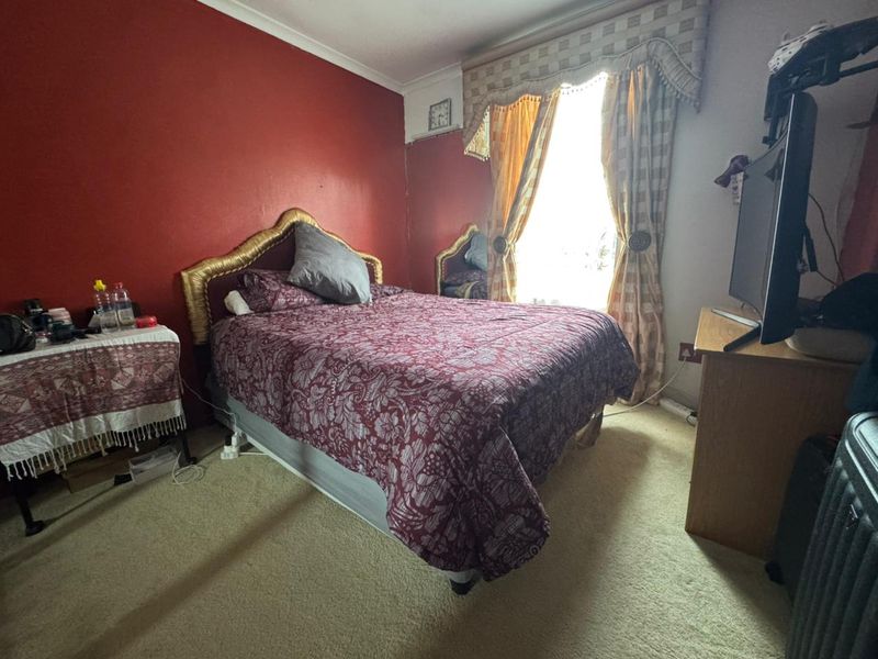 A bedroom featuring carpeted flooring and coving, currently requiring cosmetic updates to improve the overall aesthetic and condition of the space.