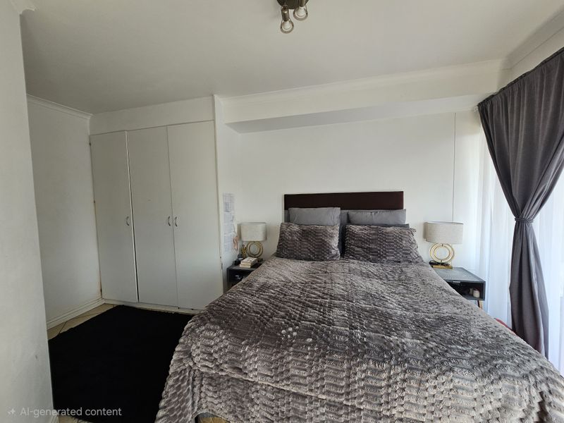 A bedroom featuring built-in cupboards, tiled flooring, and cove cornicing, offering a functional space with neutral finishes.