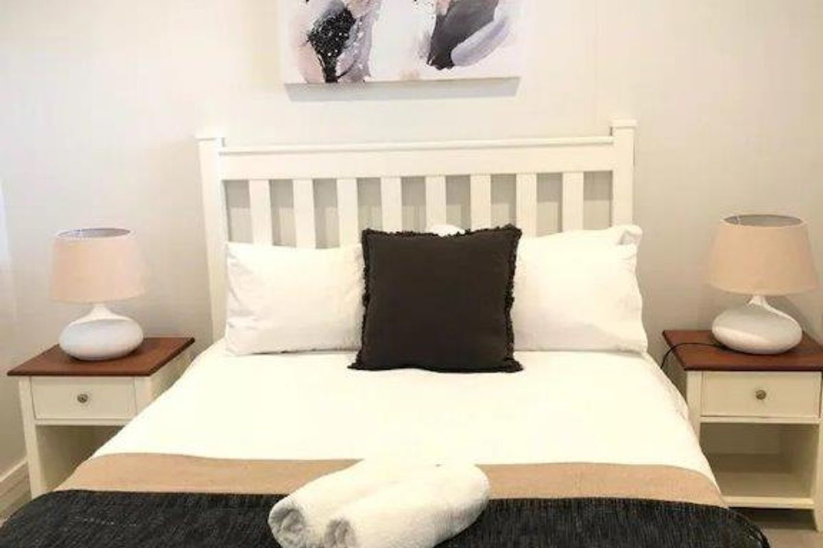 A well-maintained bedroom featuring neutral wall tones and a clean, simple layout suitable for comfortable living.