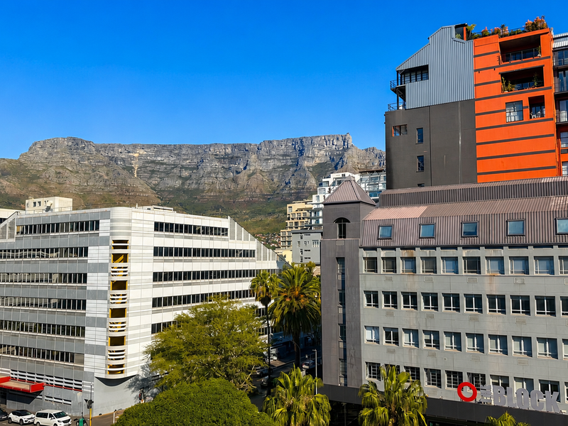 An elevated urban view showcasing the surrounding city architecture with Table Mountain in the background.