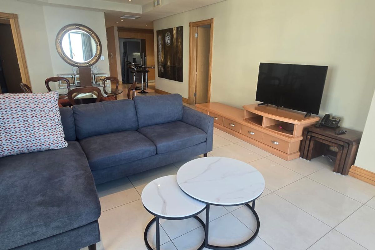 Spacious open-plan living area featuring neutral tiled flooring, recessed lighting, and timber door frames, providing a functional and well-lit space for relaxation.