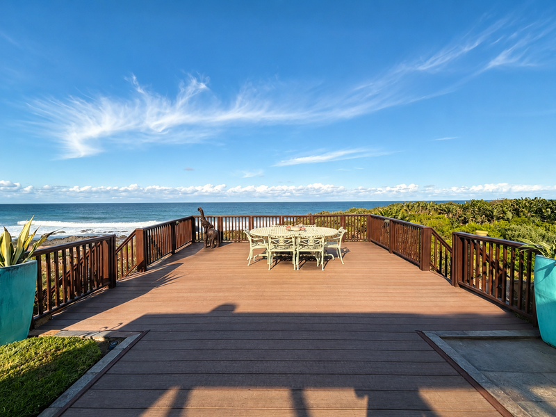 Spacious elevated timber deck featuring a secure balustrade and panoramic ocean views, perfect for outdoor entertaining.
