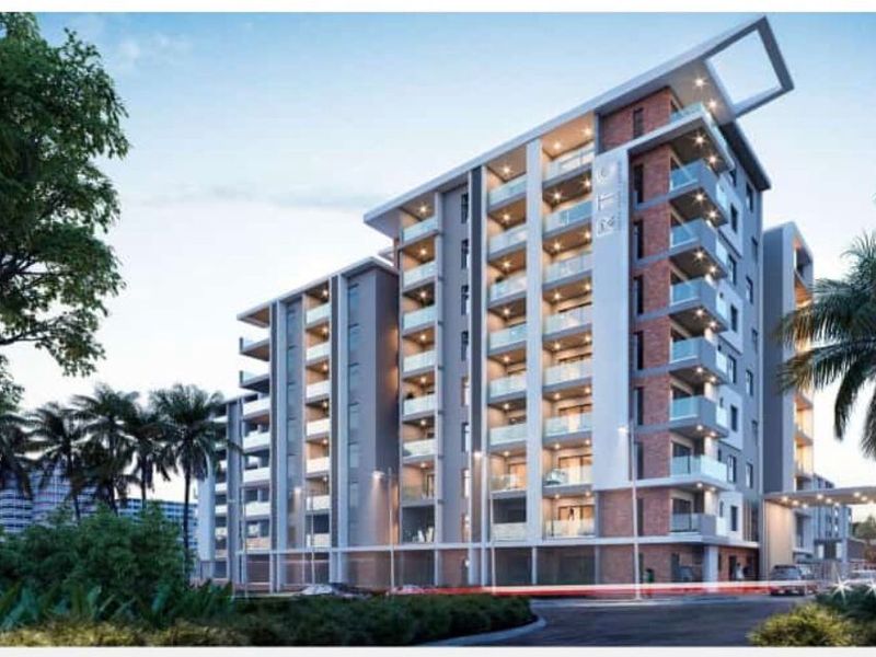 A modern multi-story apartment building featuring contemporary brick and glass facade design with private balconies.