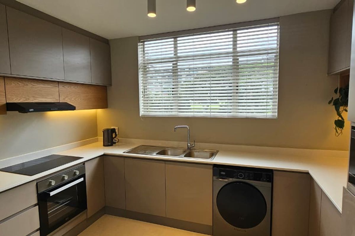 Modern, well-appointed kitchen featuring sleek cabinetry, stone countertops, integrated appliances, and ample under-cabinet lighting, creating a functional and contemporary culinary space.