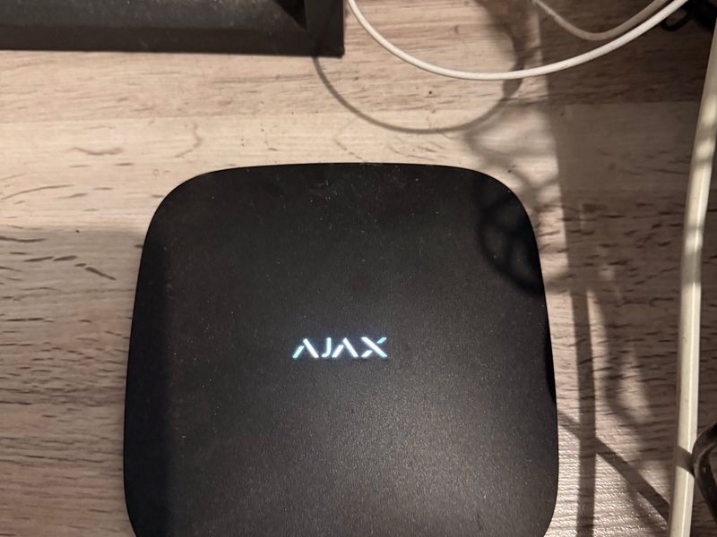 A close-up view of an Ajax security system hub device.