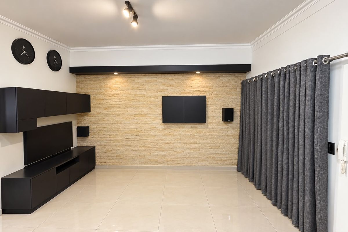 Modern living room featuring a stone accent wall, built-in cabinetry, tiled flooring, and elegant cornicing, creating a sophisticated and well-maintained space.