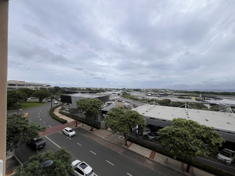 An elevated view overlooking the surrounding urban landscape, street infrastructure, and commercial buildings.