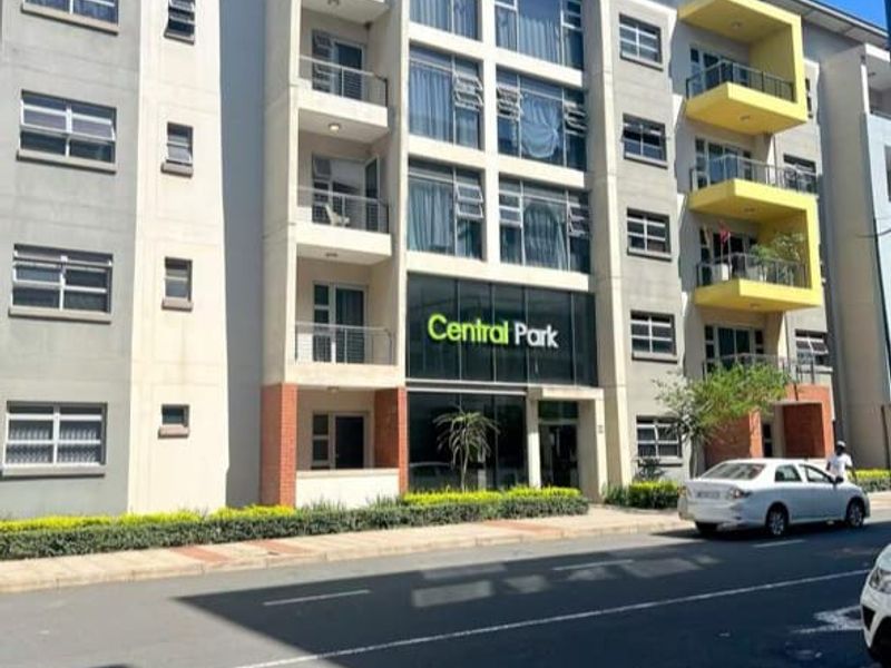 Front exterior view of the Central Park apartment complex, featuring multi-story residential units with balconies and modern architectural design.