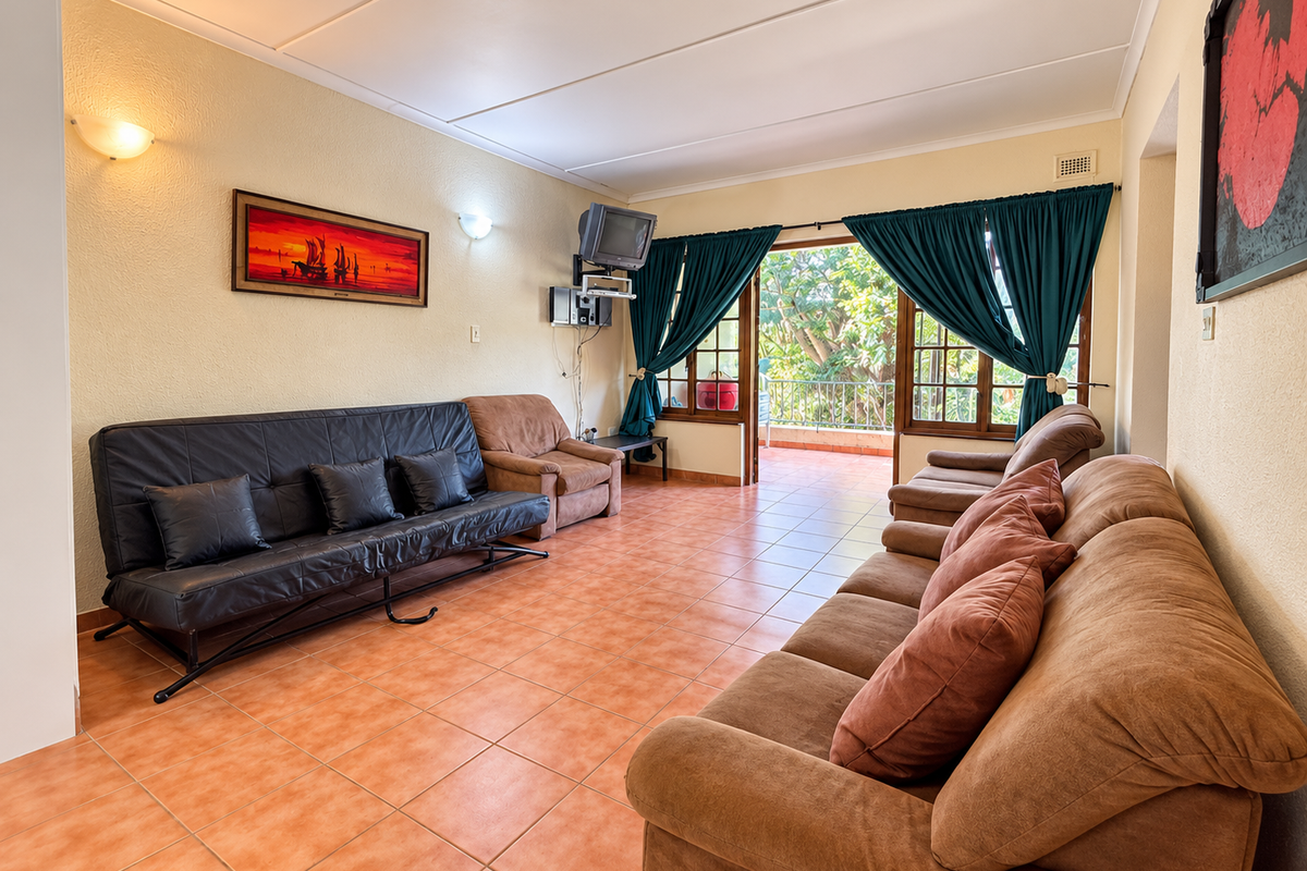 Spacious living room featuring tiled flooring and direct access to an outdoor balcony through sliding glass doors, offering a bright and functional layout.