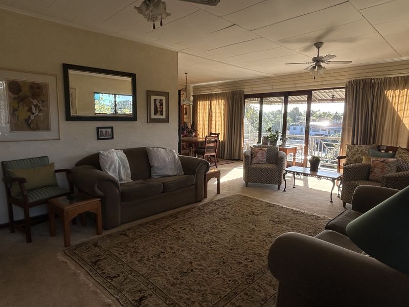 Spacious open-plan living and dining area featuring large sliding glass doors that provide natural light and access to an outdoor balcony.