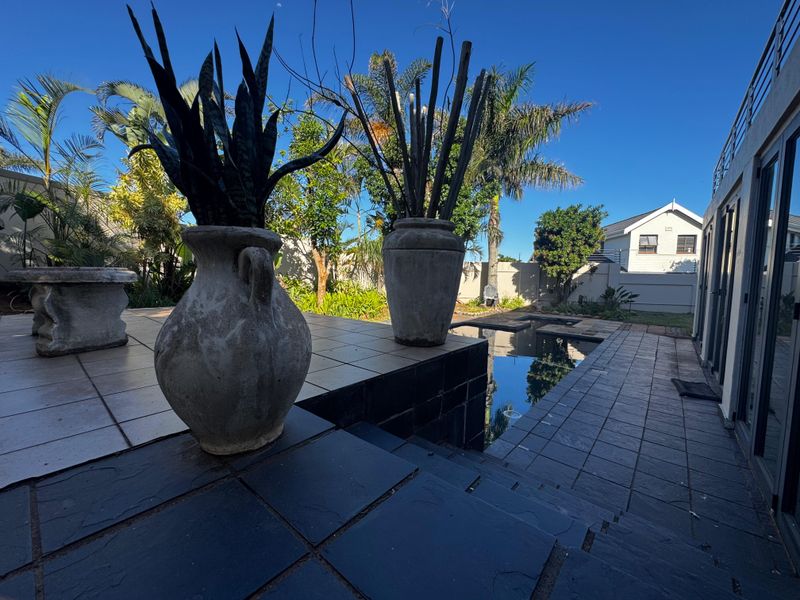 Outdoor pool area featuring a tiled patio, swimming pool, and direct access to the home through sliding glass doors.