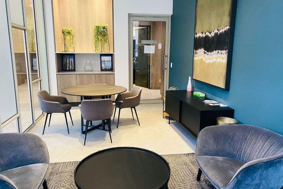 A modern, well-maintained living area featuring built-in cabinetry and a glass-panelled door, creating a bright and functional space.